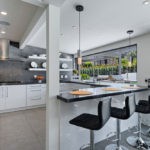 Дизайн белой кухни в интерьере просторного дома с террасой