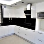 Угловой дизайн белой кухни в городской квартире