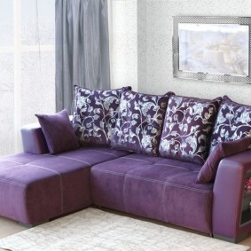 Пестрые подушки на фиолетовом диване