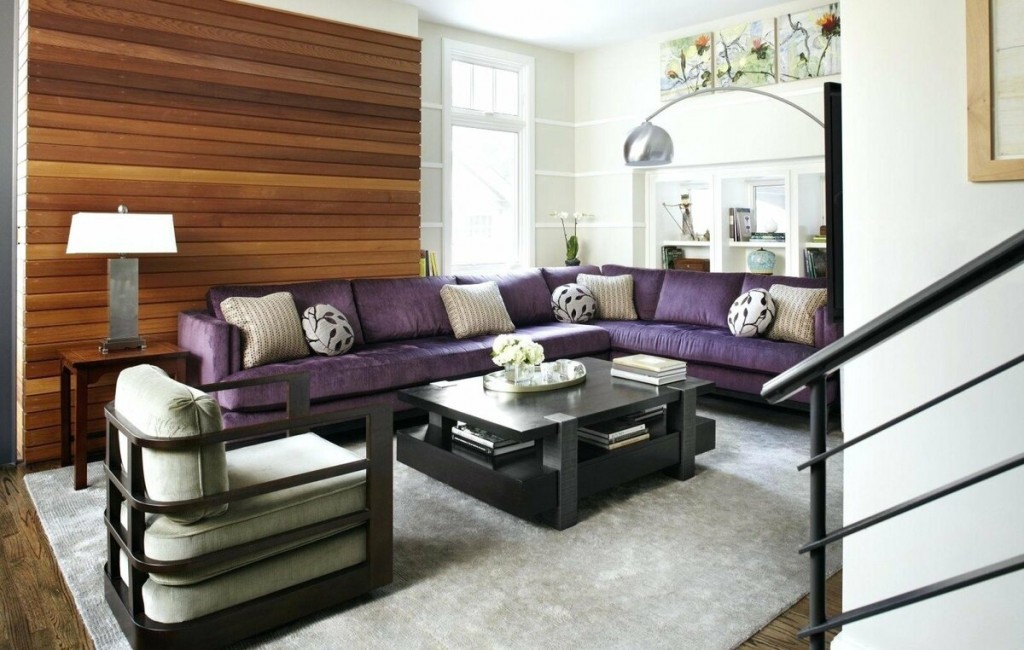 Коричневые рейки за спинкой фиолетового дивана