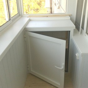 Вместительный шкафчик под окном на балконе